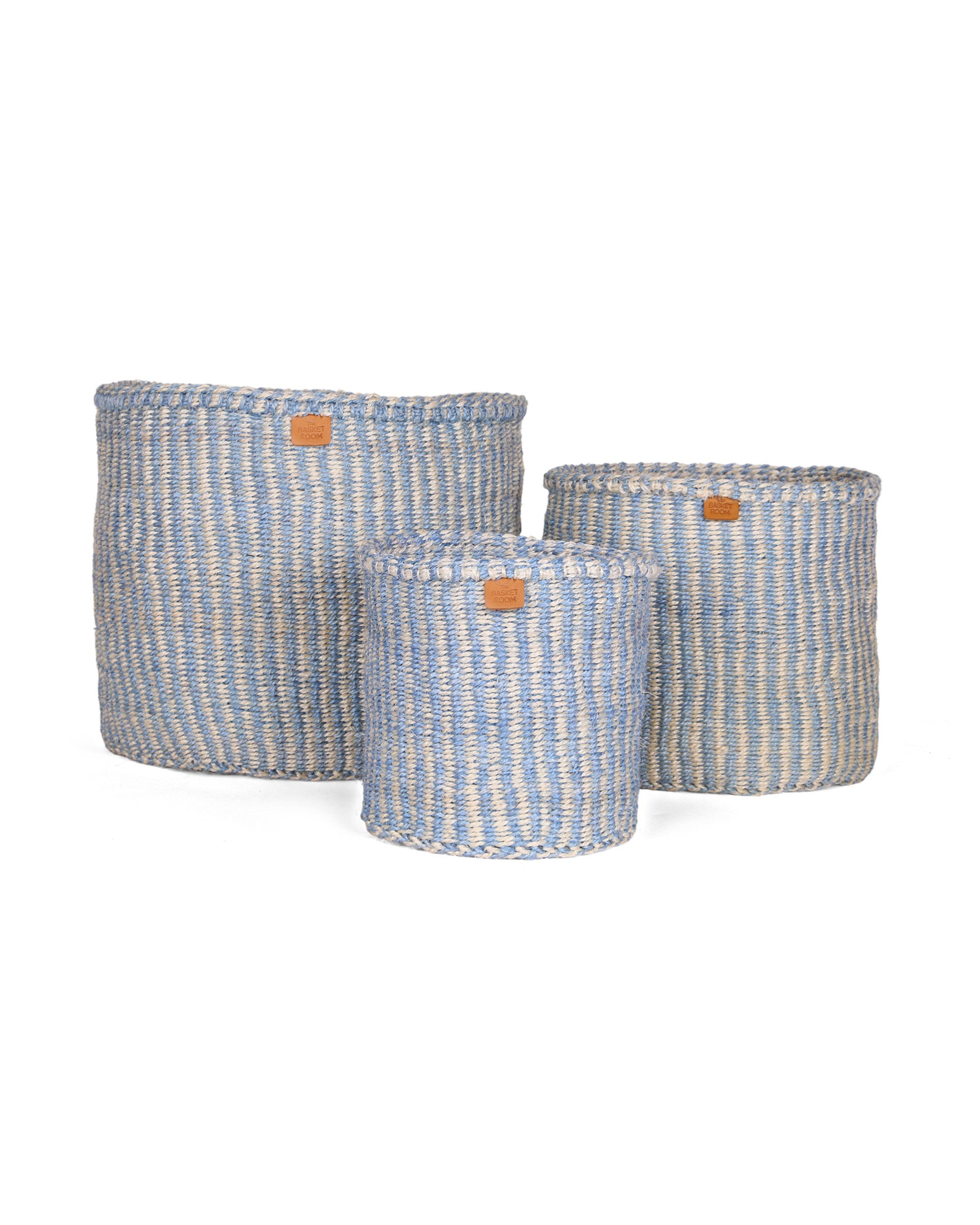Three woven baskets with blue and white pinstripe on a white background