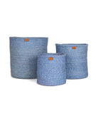Three blue woven baskets of different sizes on a white background