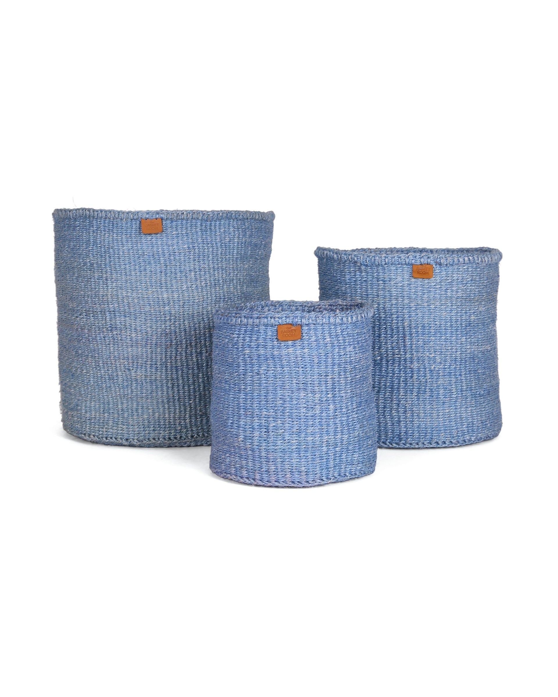 Three blue woven baskets of different sizes on a white background