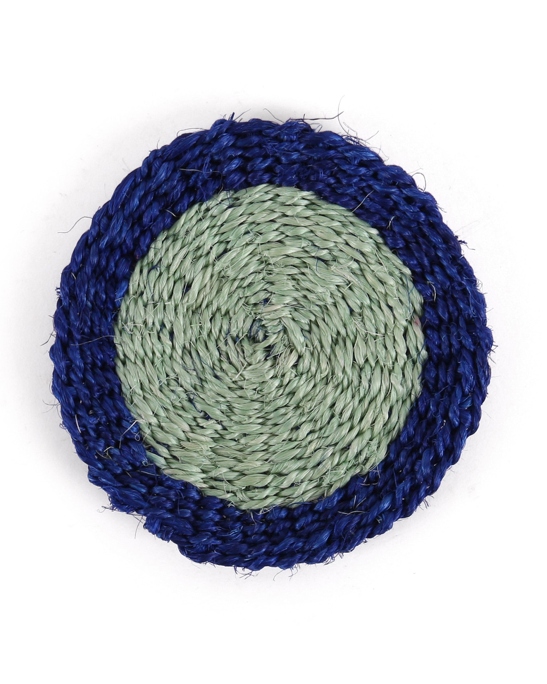 Round woven coaster with blue outer rim and green center on a white background