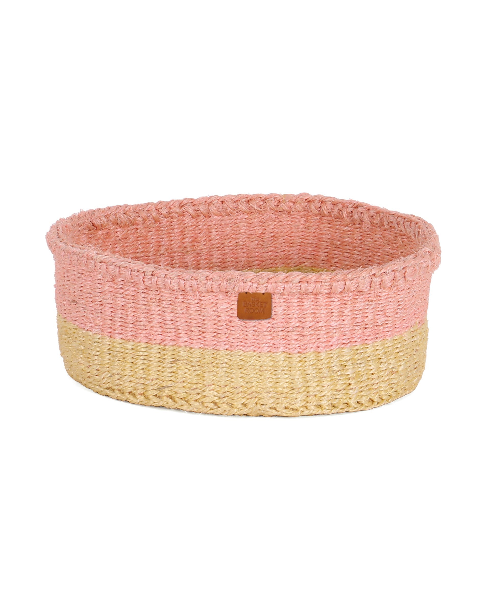 Woven basket with pink top and natural bottom on a white background